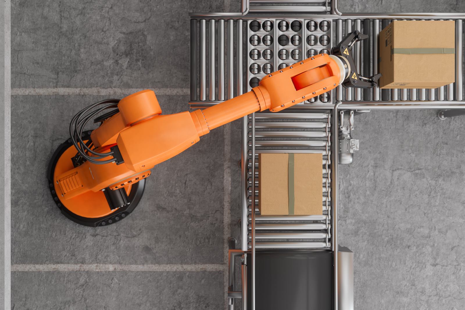 Robotic arm moving parcels along an automated conveyor